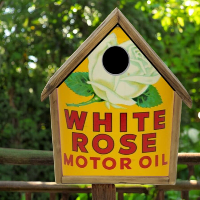 Birdhouse with White Rose Motor Oil branding against a green background