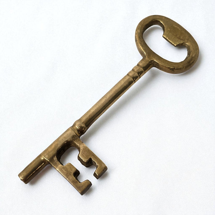 Bronze key on a white background
