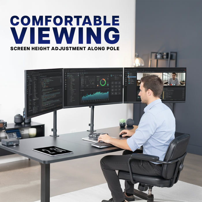 Person using a computer setup with multiple monitors in a modern office setting.