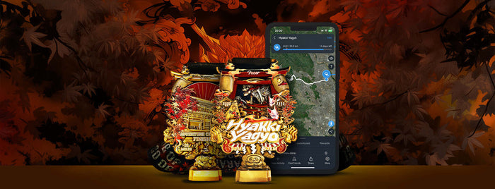 Haunted Adventures medal with Hyakki Yagyō theme and a smartphone displaying a map against a fiery, autumnal background.
