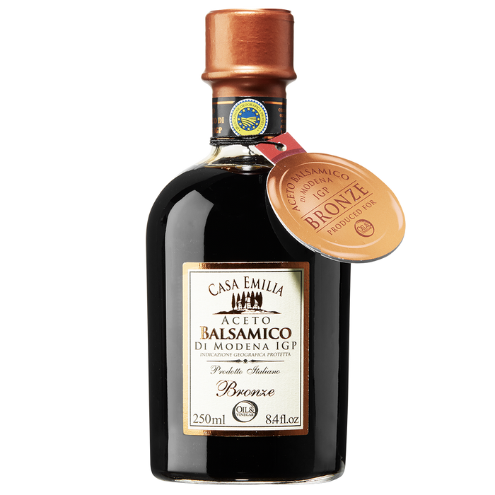 A bottle of Aceto Balsamico di Modena IGP Bronze with a copper cap and a label indicating the product is 250ml in size.