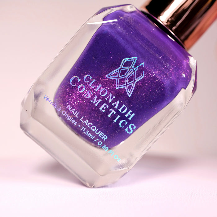 Angled, close-up of Anthocyanine Nail Lacquer bottle on a light background.