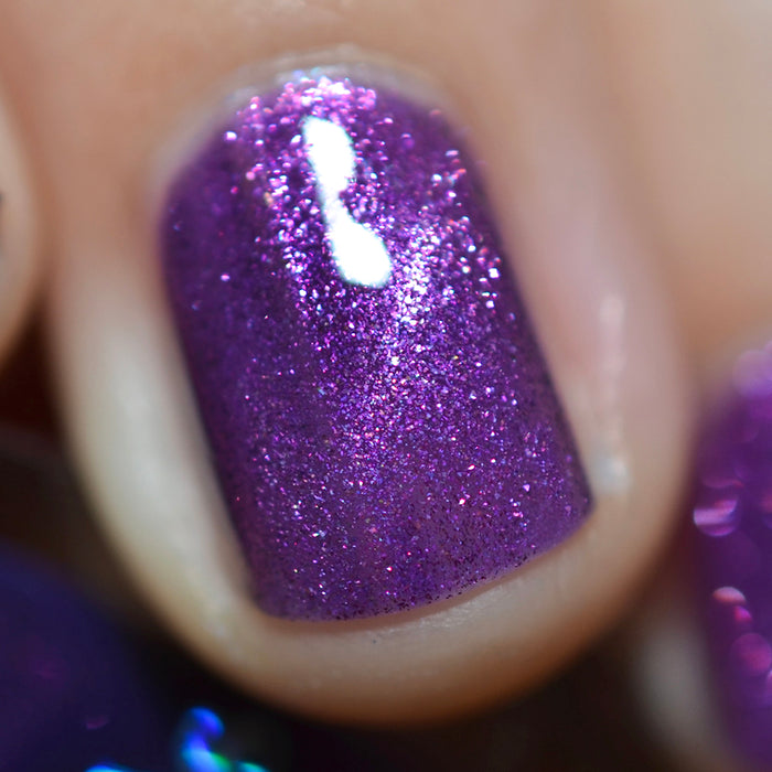 Close-up of one nail painted with Anthocyanin Nail Lacquer on fair skin tone. Emphasizes purple shimmer particles.