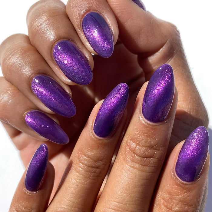 Nails painted with Anthocyanin Nail Lacquer on medium skin tone, on a white background.