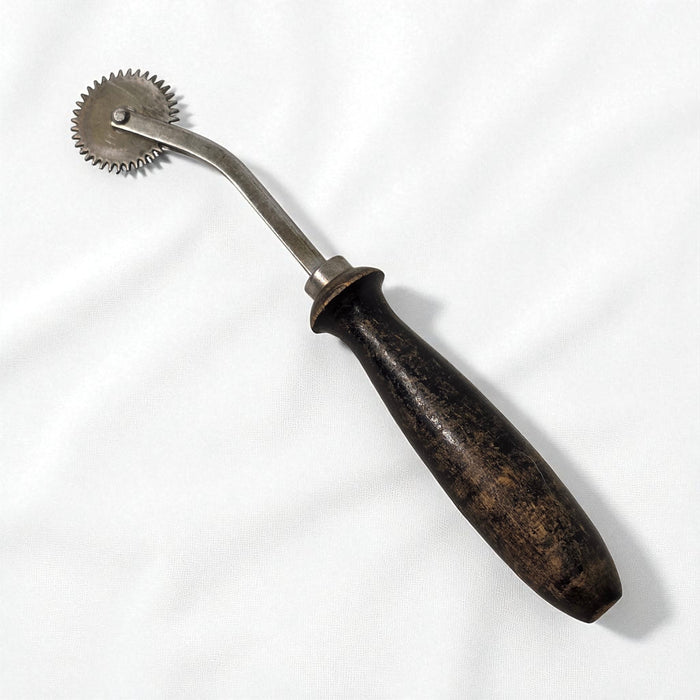Vintage metal tool with wooden handle on a white background