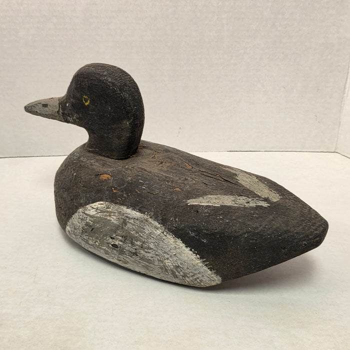Wooden duck decoy on a light gray background