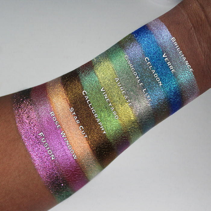Arm swatches of Aureate as well as the other 9 Holiday Countdown Box shadows on deep skin tone.