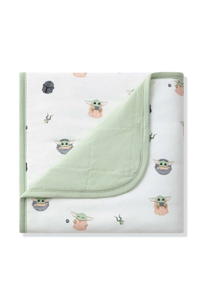 Baby Blanket in Grogu™ with the corner folded down showing the light green quilted backing
