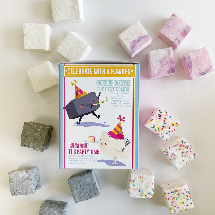 Vanilla, Cotton Candy, Cookies and Cream, and Funfetti marshmallows surround the packaging for their Birthday Wishes Variety Pack. This side features an illustration of a cookies and cream marshmallow with a party hat & blowing a noise making and a funfetti marshmallow holding a slice of cake.