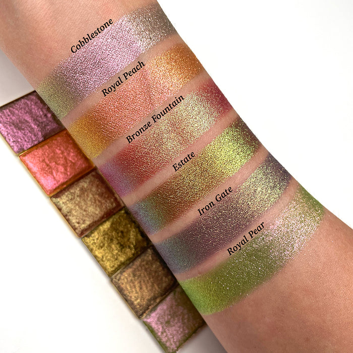 Top angled arm swatches on fair skin tone of Bronze Fountain Earth Vibrant Multichrome Eyeshadow shifts compared to Cobblestone, Royal Peach, Estate, Iron Gate and Royal Pear