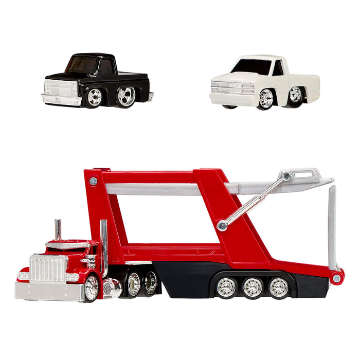 Toy truck with a trailer with two smaller toy trucks on a white background