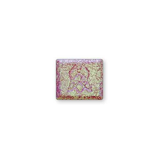 A single multichrome eyeshadow in colour Cephalopod on a white background. A large particle glitter shadow with a pinky-mauve base and bright green-aqua-pink shifts.