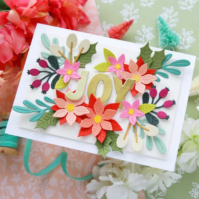 Card with floral decorations spelling 'JOY' on a floral background alex syberia designs die