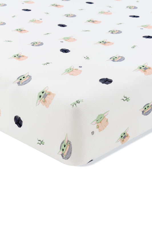 Corner of the Crib Sheet in Grogu™ shown on a crib mattress
