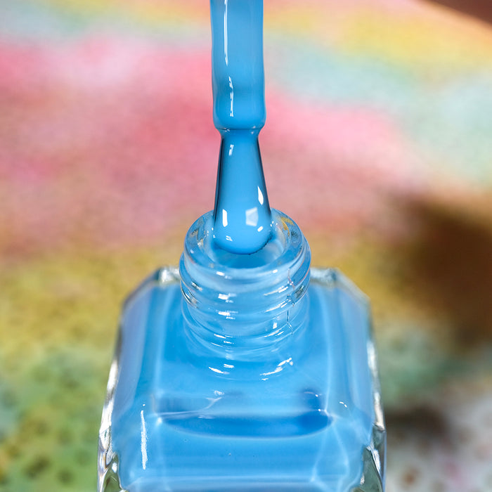 Close-up of opened nail polish bottle containing Cumulus Nail Lacquer, with brush showing.