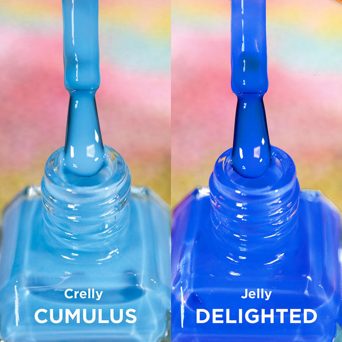 Two open bottles of nail polish with brushes showing. Comparing blues of Cumulus and Delighted Nail Lacquers.