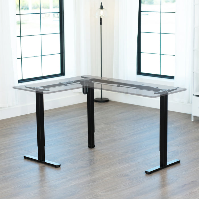 L-shaped adjustable desk in a bright room with large windows