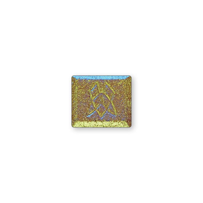 A single multichrome eyeshadow in colour Fools Gold on a white background. A warm brown base with yellow-lime-aqua shifts and hints of purple.