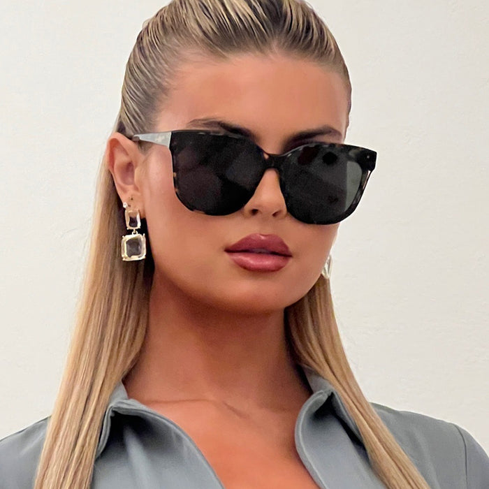 lifestyle - female wearing gia square oversized sunglasses with a espresso tortoise frame and grey lenses