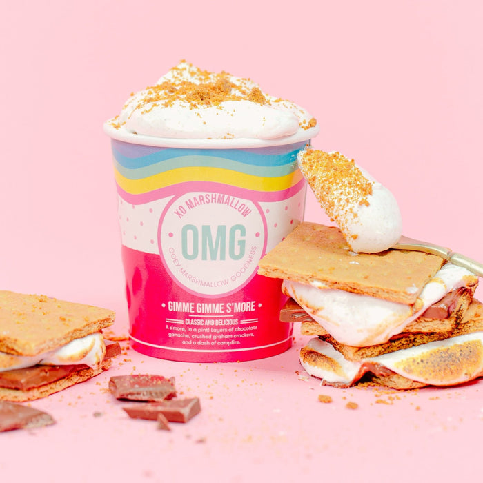 A pint of XO Marshmallow s'mores flavored fluff next to s'mores made with fluff and a spoon full of marshmallow creme that's been toasted