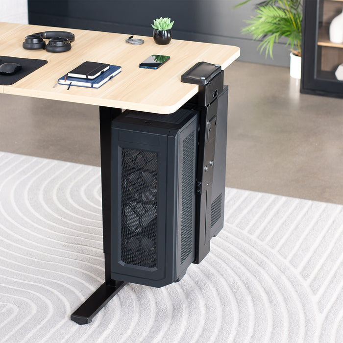 Computer tower mounted under a desk on a clamp-on PC mount in an office setting.