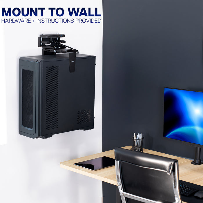 PC mounted to wall on an Under Desk and Wall PC Mount shown on a white wall above a desk.