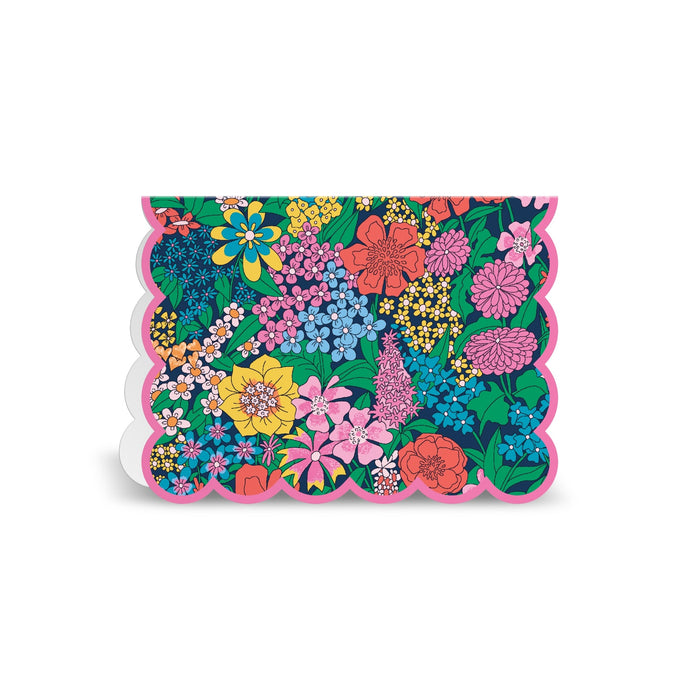 The Liberty Premium Notecard Set by Liberty London features scalloped-edge cards with bright, colorful floral patterns and greenery on a dark background, finished with a pink border.