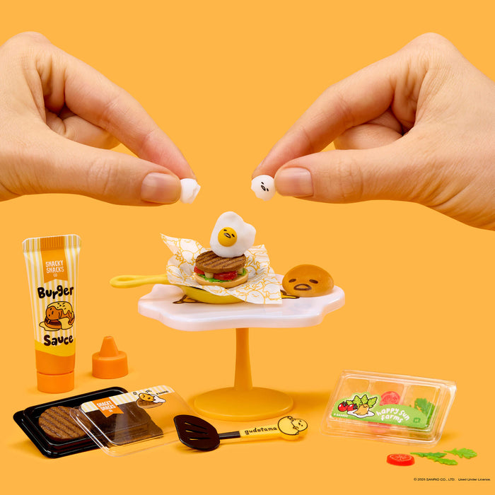 Miniature food set with hands interacting on a yellow background
