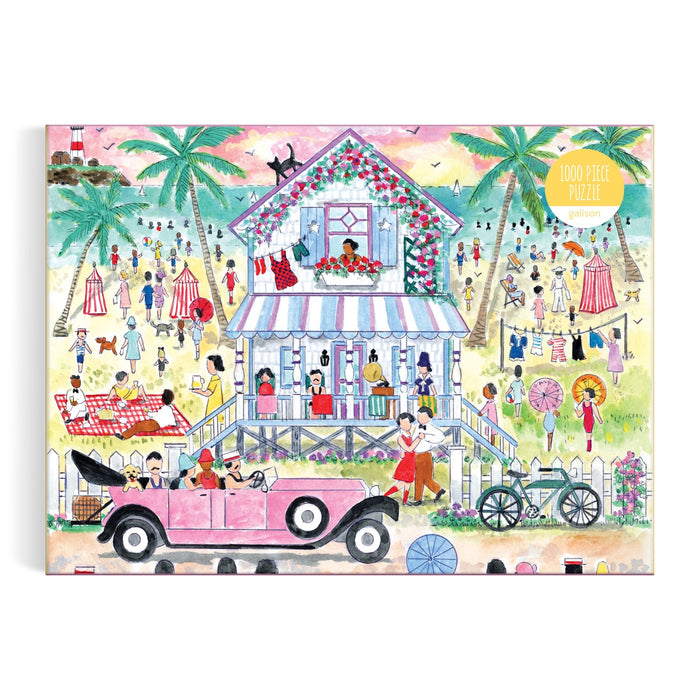 The Michael Storrings Roaring 20s Beach House 1000 Piece Puzzle by Michael Storrings features a vibrant illustrated scene of people in vintage attire, a two-story house, palm trees, a pink car, bicycle, and lively beach activities.