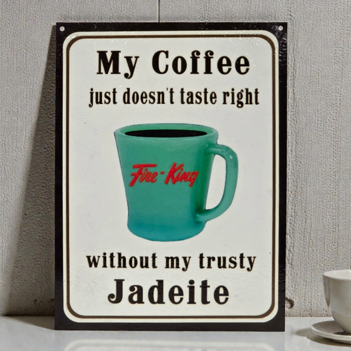 Decorative sign with a teal mug and text about coffee and Jadeite on a gray background.