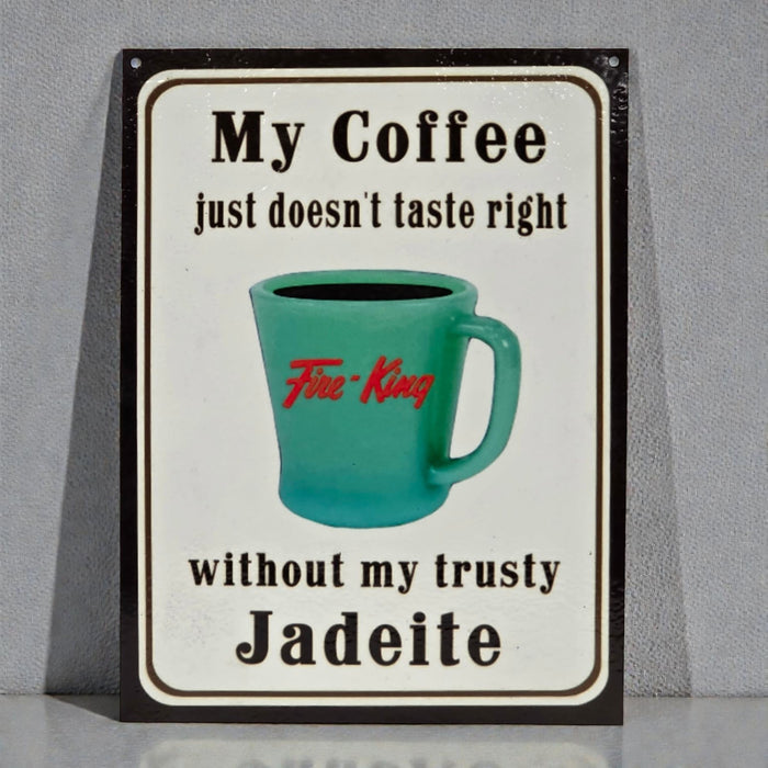 Sign with a teal mug graphic and text about coffee and Jadeite on a gray background