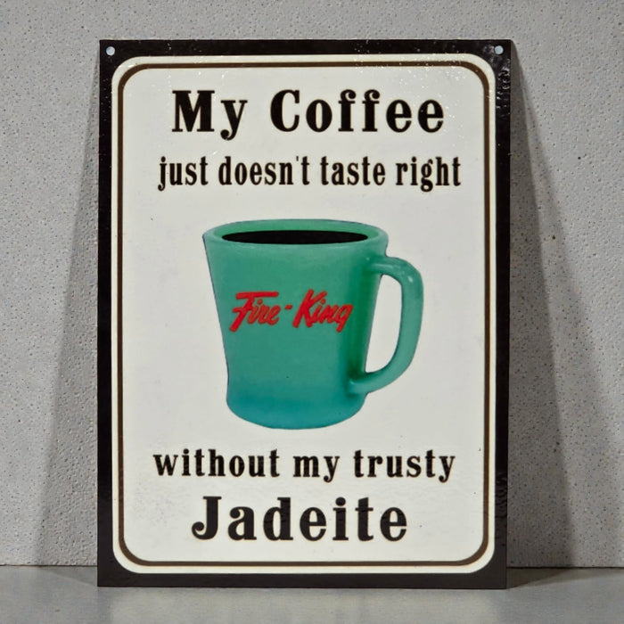 Metal sign with turquoise mug graphic and text on a gray background