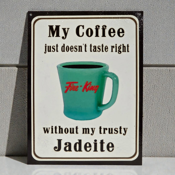 Sign with a teal mug and text about coffee and Jadeite on a gray background