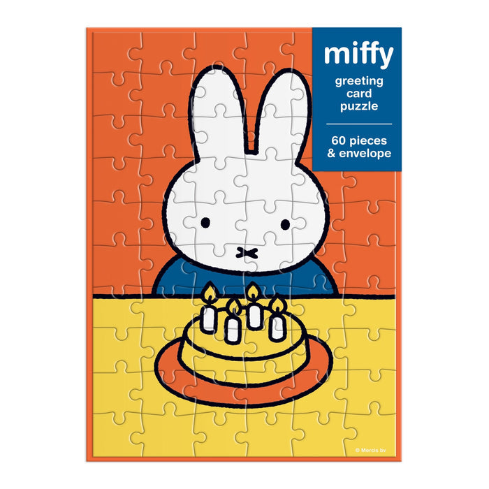 The Miffy Birthday Greeting Card Puzzle by Miffy is a 60-piece puzzle showing Miffy the bunny at a table with a birthday cake topped with four candles, set against an orange background.