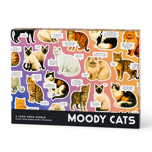 The Brass Monkey Moody Cats 1000 Piece Puzzle features illustrated cats of various breeds, each with unique expressions and speech bubbles on a vibrant gradient—perfect for cat lovers and puzzle fans alike.