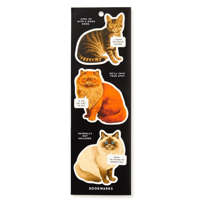 The Brass Monkey Moody Cats Magnetic Bookmark Set features three black cat-shaped bookmarks with speech bubbles like “The purr of this cliffhanger” and “Sorry, I'm not here to judge you”—perfect for adding humor to your reading!.