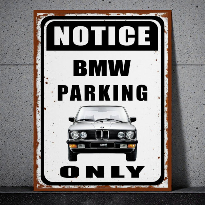 Vintage-style metal sign with BMW logo and text 'Notice BMW Parking Only' on a concrete wall.