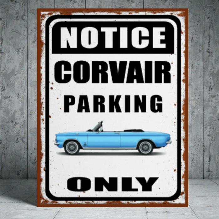 Vintage-style metal sign with a blue Corvair car and text 'Notice Corvair Parking Only' on a concrete wall background.