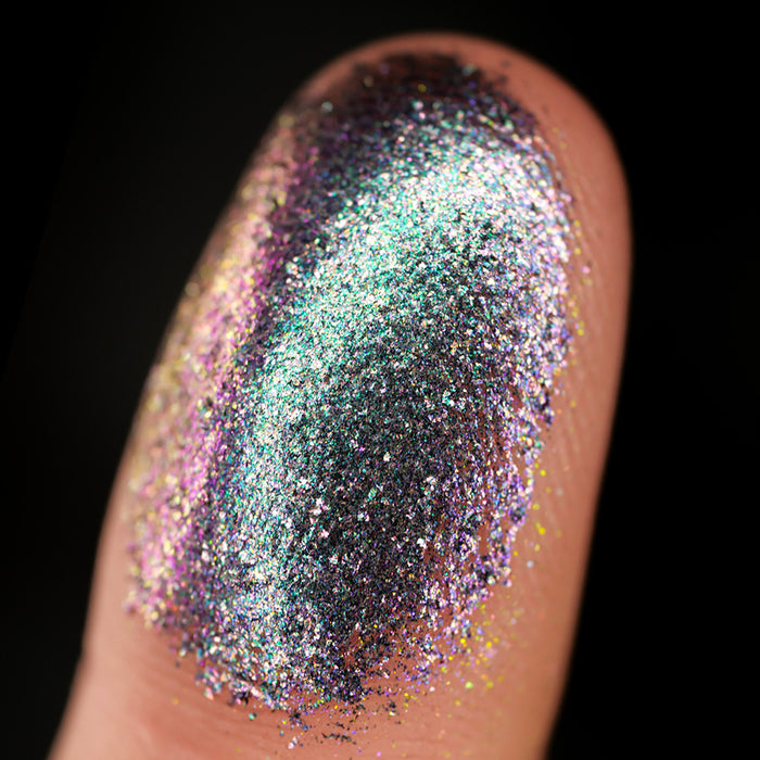 Macro finger swatch of Oxidize Dimensional Multichrome on fair skin tone.