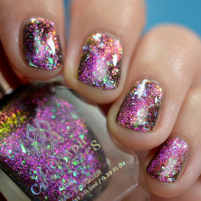 Close-up of nails painted with Pholiotina Nail Lacquer on fair skin tone. Hand is holding polish bottle.