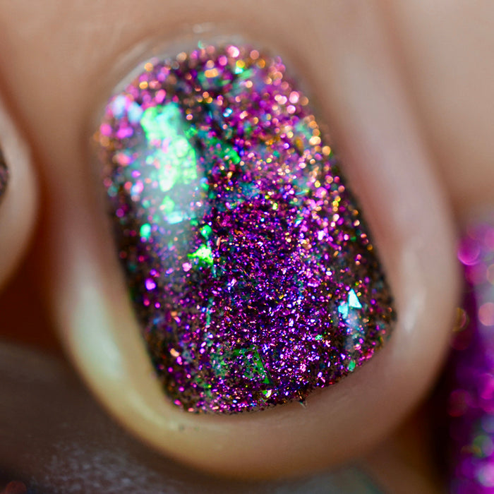 Close-up of one nail painted with Pholiotina Nail Lacquer on fair skin tone. Emphasizes flakey glitter.