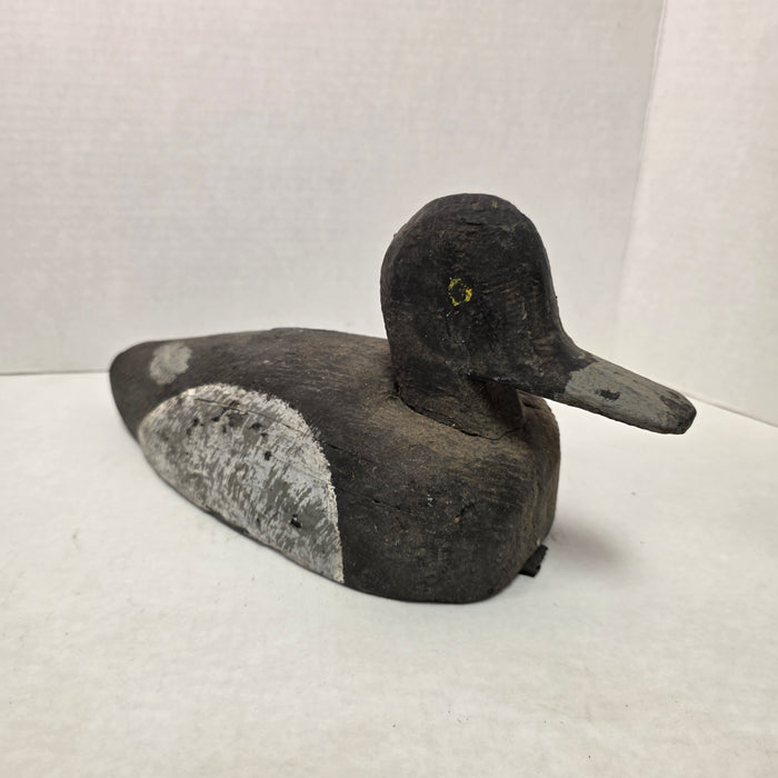 Wooden duck decoy on a white background