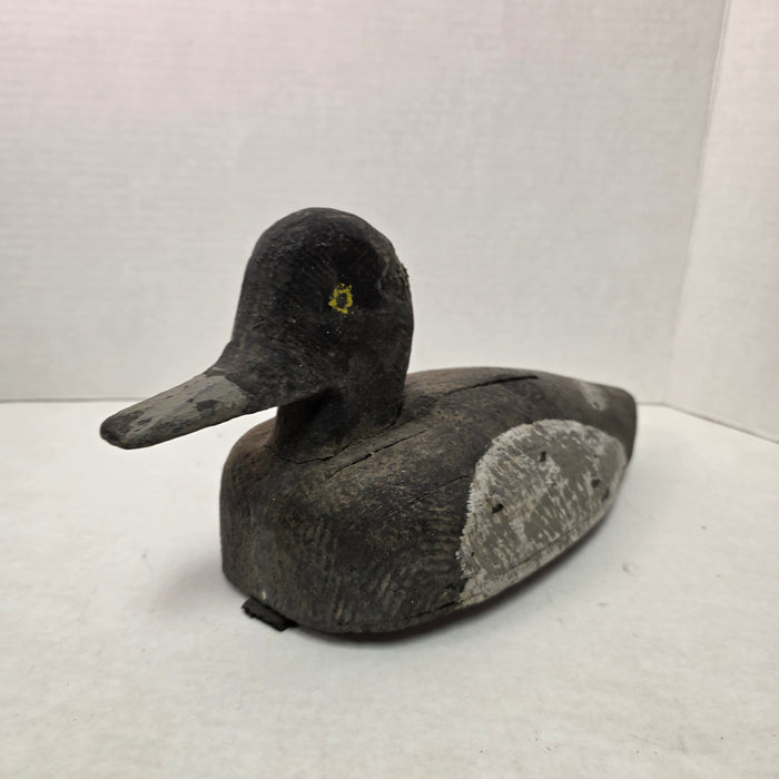 Wooden duck decoy on a white background