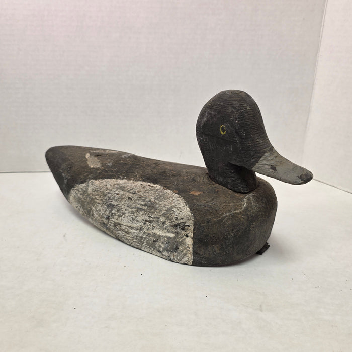 Wooden duck decoy on a white background
