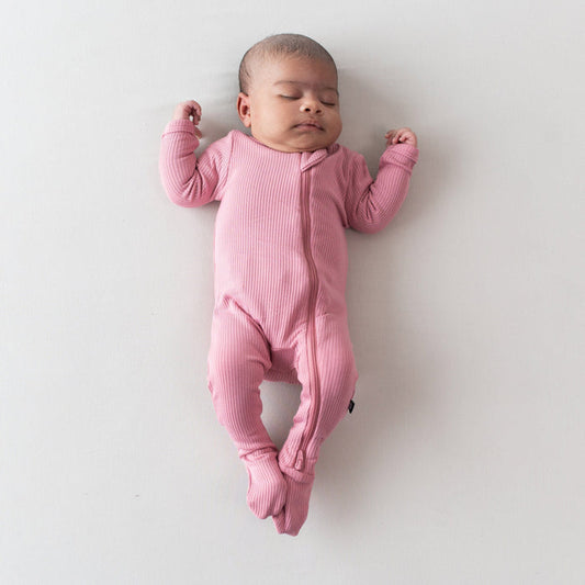 Newborn wearing Ribbed Zipper Footie in Apple Blossom pink