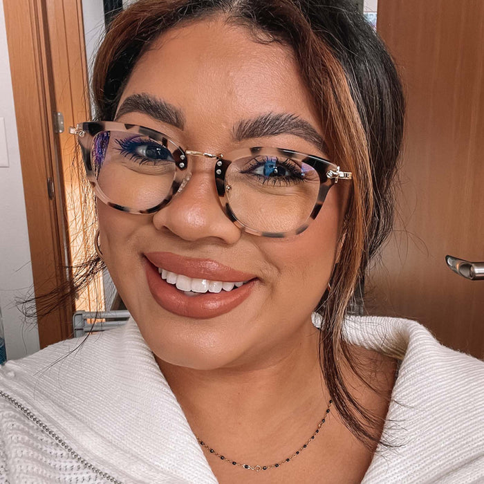 lifestyle - female wearing rue himalayan tortoise blue light technology glasses