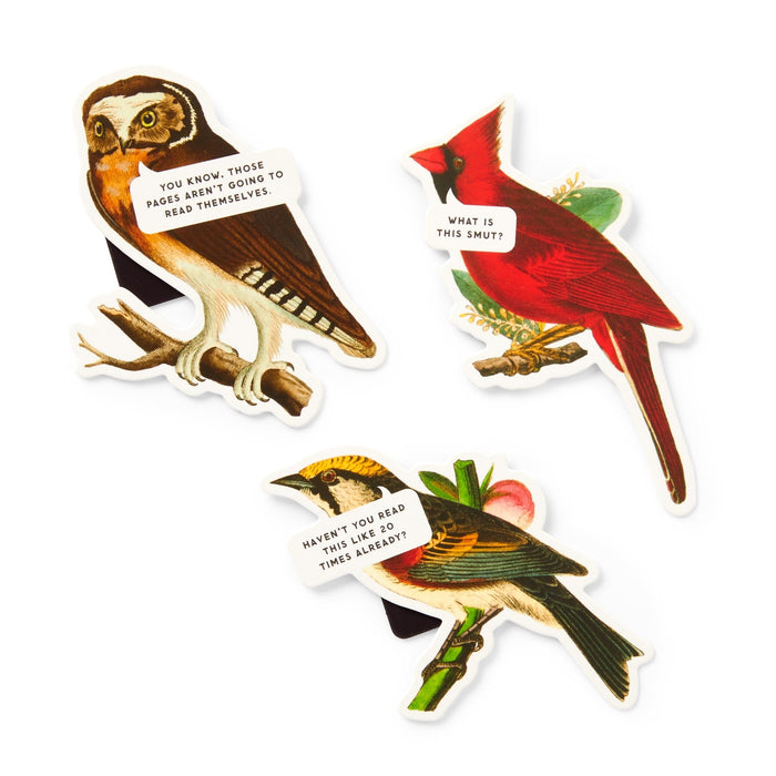 The Salty Birds Magnetic Bookmark Set by Brass Monkey includes three illustrated bird bookmarks—an owl, a cardinal, and a yellow bird—each with witty reading-themed speech bubbles that add quirky charm to your page.
