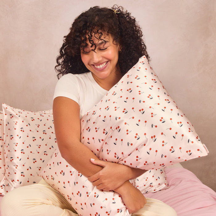Detail close-up of Kitsch Satin Pillowcase in Cherry Print showing smooth satin texture and printed cherries