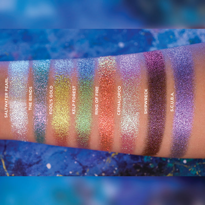 Arm swatches on medium skin tone of all eight eyeshadows included in the Deep Sea Treasures Palette.