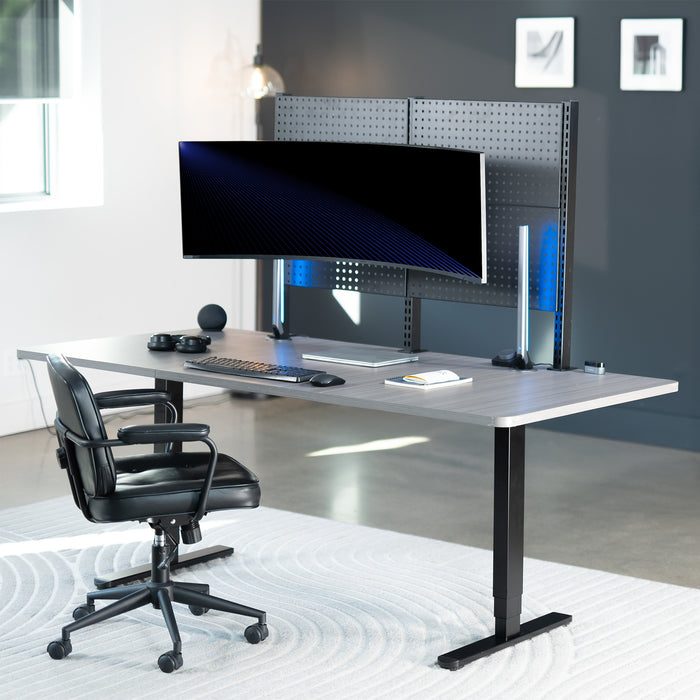 Modern office desk with computer setup showcasing a monitor mounted on a peg board in a bright room